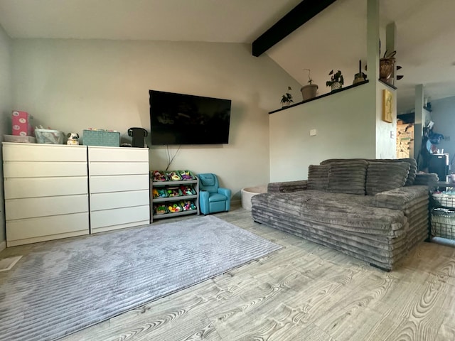 living room with lofted ceiling with beams