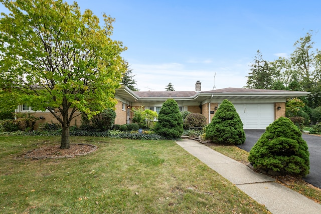 view of front of property with a garage and a front lawn