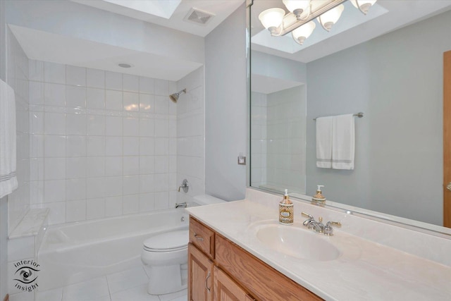 full bathroom featuring tile patterned flooring, vanity, tiled shower / bath combo, and toilet