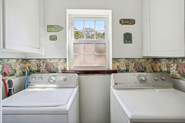 clothes washing area featuring cabinets and independent washer and dryer