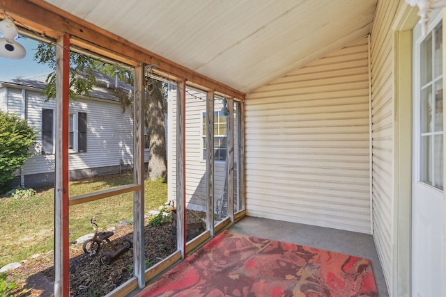 unfurnished sunroom featuring lofted ceiling and wooden ceiling