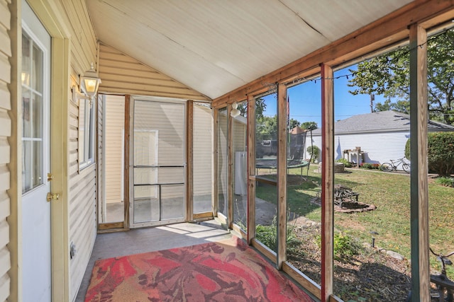 sunroom / solarium featuring lofted ceiling