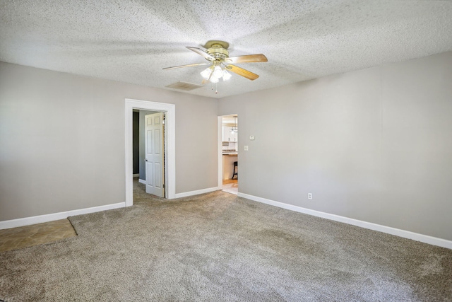 unfurnished bedroom featuring ceiling fan, a textured ceiling, and carpet