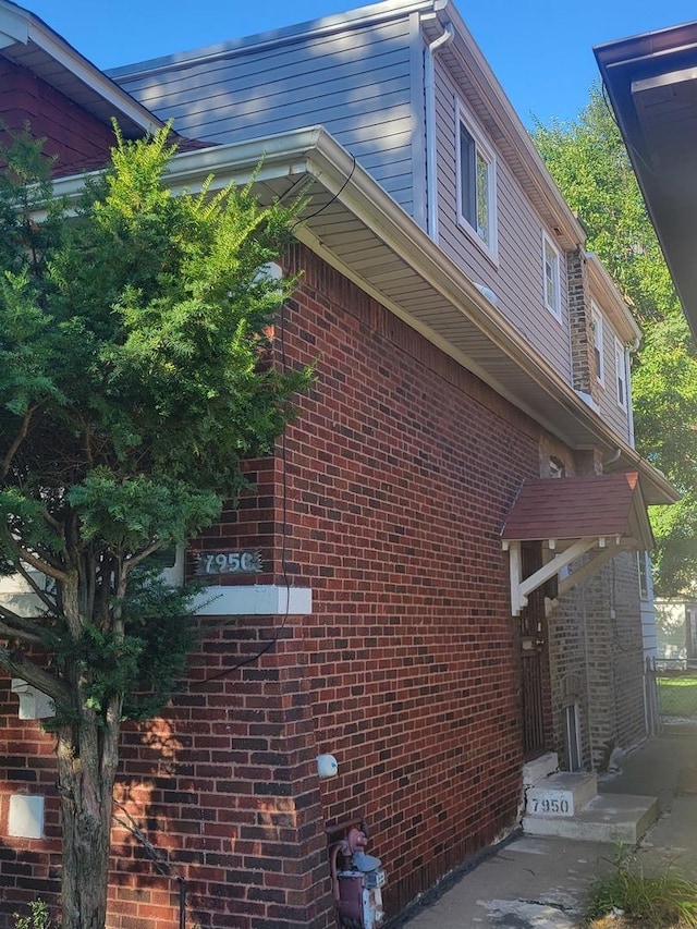 view of side of home featuring brick siding