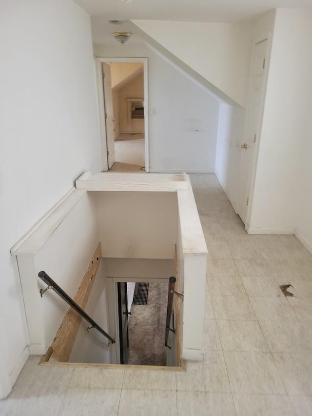 stairs with tile patterned floors and vaulted ceiling