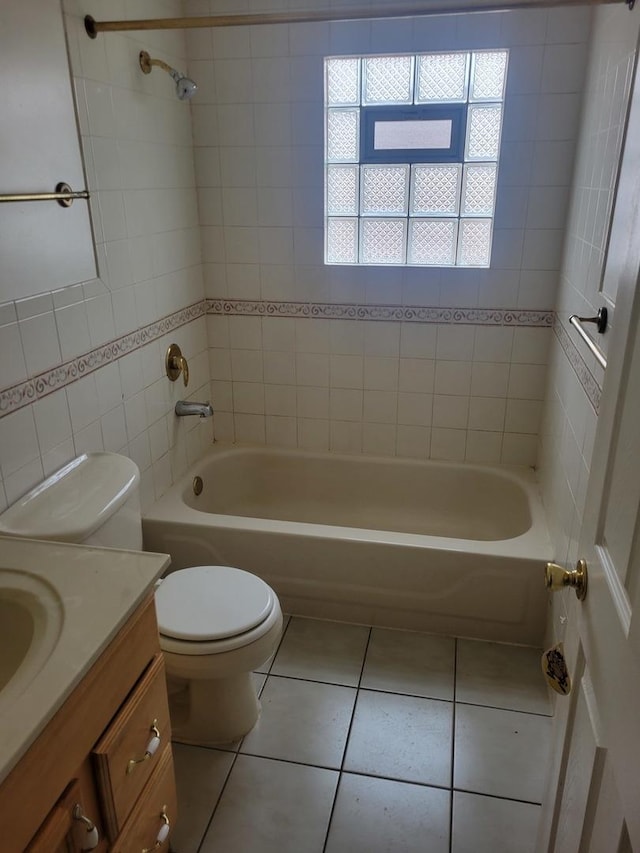 bathroom featuring toilet, vanity,  shower combination, and tile patterned flooring