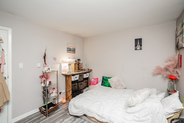 bedroom with wood-type flooring