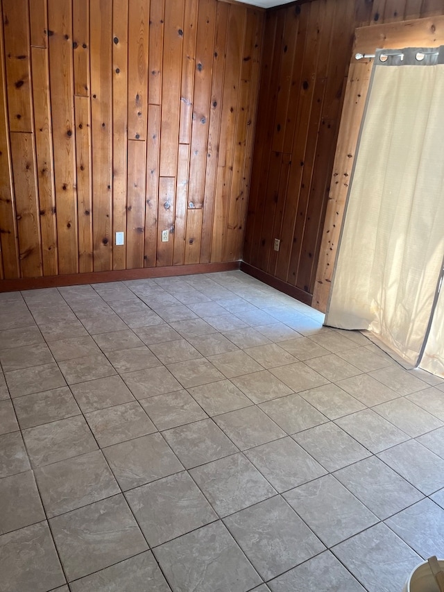 tiled spare room with wooden walls