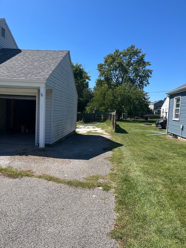 view of side of property with a yard and a garage