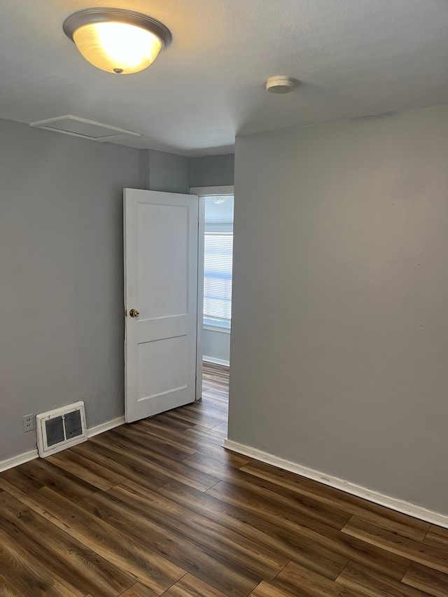 spare room featuring dark hardwood / wood-style flooring