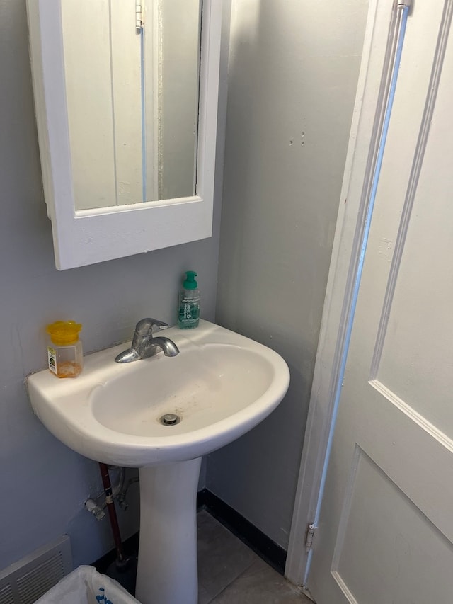 bathroom featuring tile patterned flooring and sink