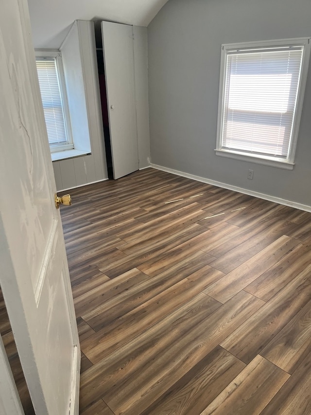 bonus room with dark hardwood / wood-style flooring