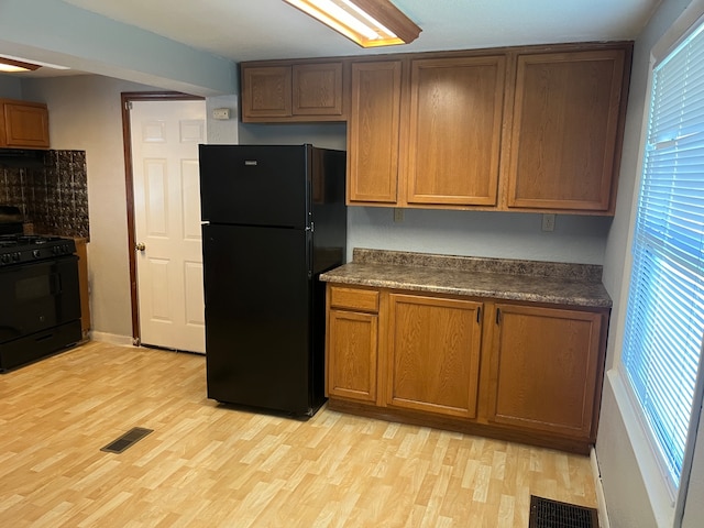 kitchen featuring black appliances and light hardwood / wood-style floors