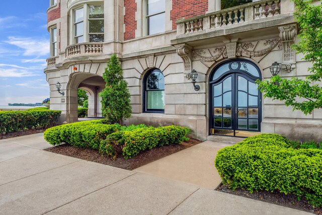 property entrance with french doors and a balcony