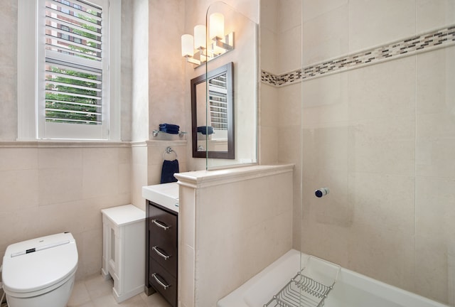 bathroom with vanity, toilet, a tile shower, and tile patterned flooring