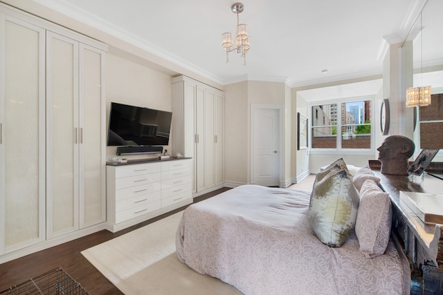 bedroom featuring an inviting chandelier, ornamental molding, and dark wood-type flooring