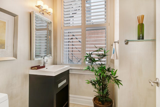 bathroom with vanity, toilet, and radiator