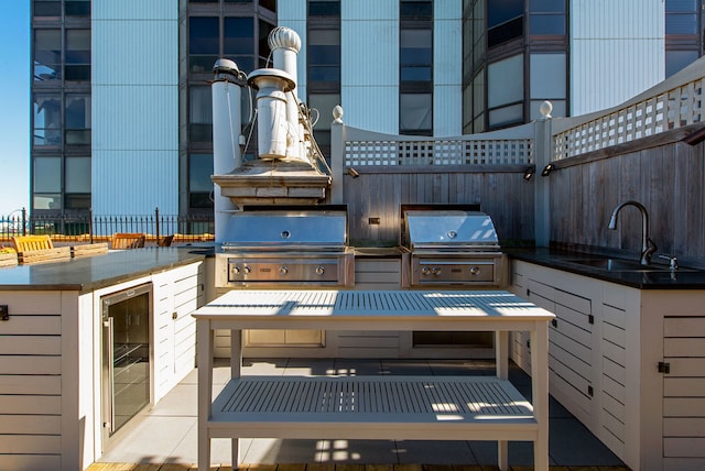 view of patio / terrace with sink, exterior kitchen, grilling area, and beverage cooler