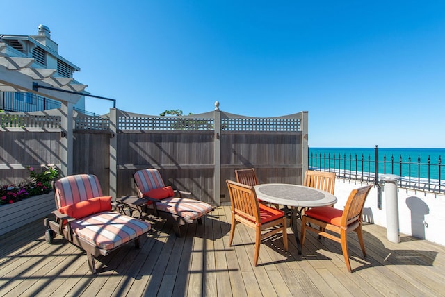 wooden deck with a view of the beach and a water view