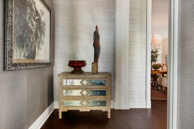 hall with an inviting chandelier and dark wood-type flooring