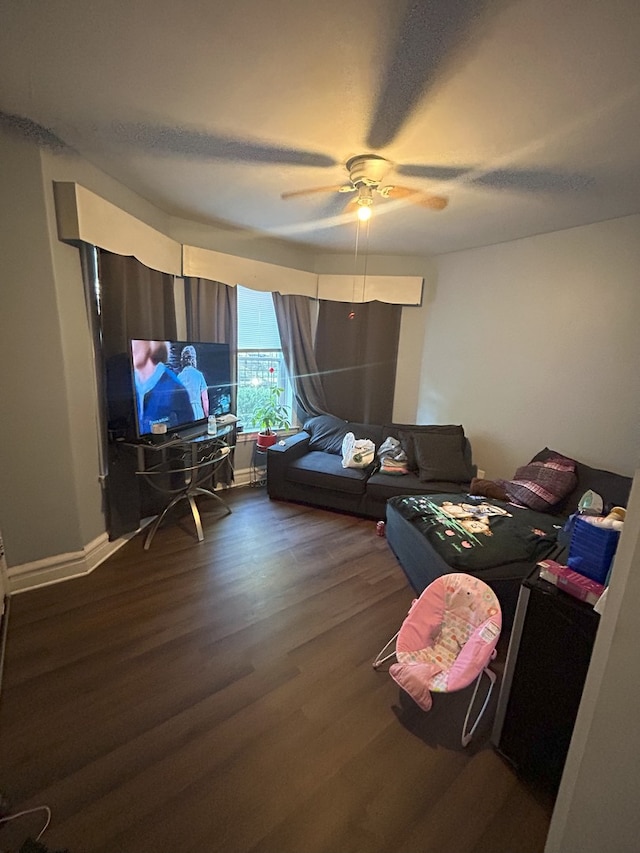 home office with ceiling fan and dark hardwood / wood-style floors