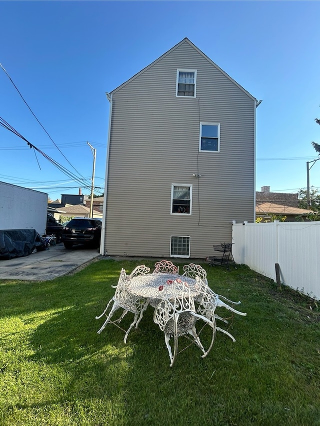 rear view of house featuring a yard