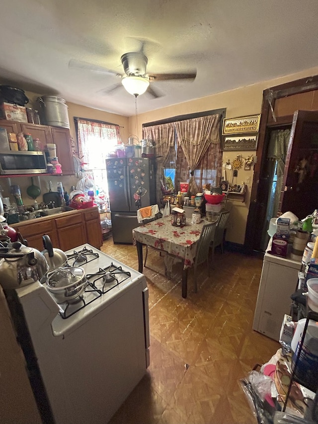 interior space with ceiling fan and stainless steel appliances