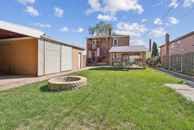 view of yard featuring a fire pit and a gazebo