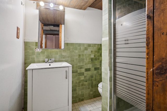 bathroom with vanity, wooden ceiling, tile walls, toilet, and tile patterned floors