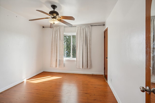 empty room featuring light wood-type flooring and ceiling fan