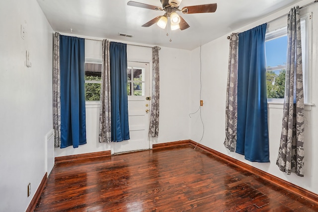 spare room featuring ceiling fan and dark hardwood / wood-style flooring