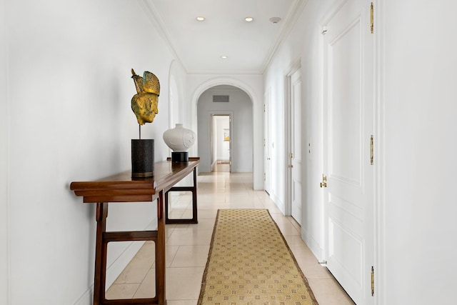 hall featuring visible vents, crown molding, light tile patterned floors, recessed lighting, and arched walkways