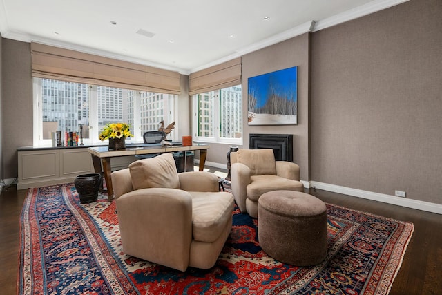 living room with ornamental molding, a fireplace, baseboards, and wood finished floors