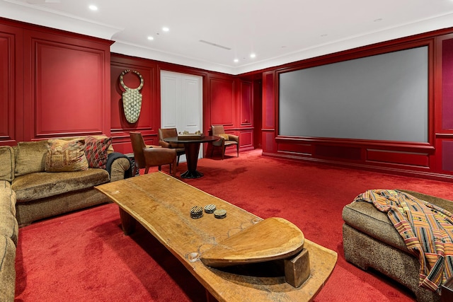 cinema room featuring crown molding, a decorative wall, recessed lighting, and carpet