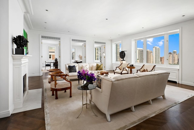 living room with a high end fireplace, a city view, crown molding, and baseboards