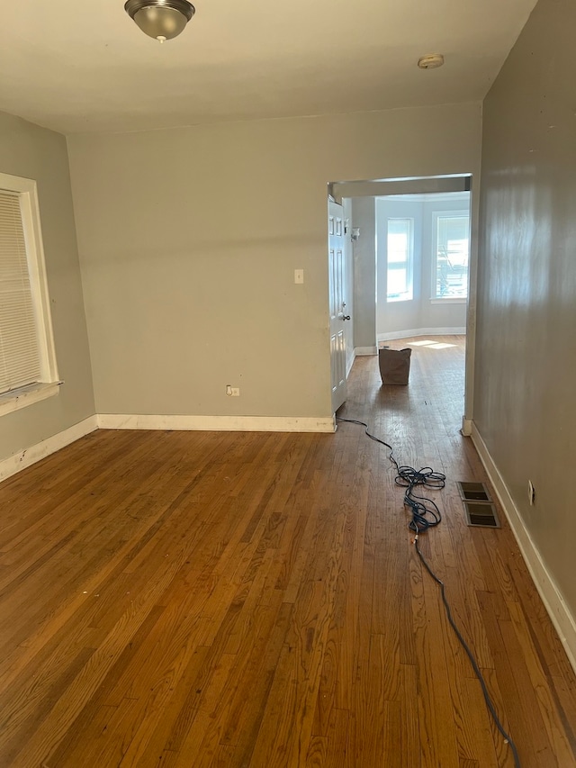 unfurnished room with hardwood / wood-style floors