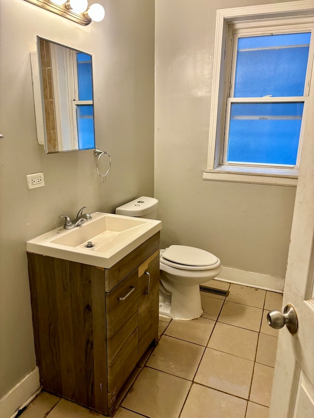 bathroom featuring vanity, toilet, and tile patterned flooring