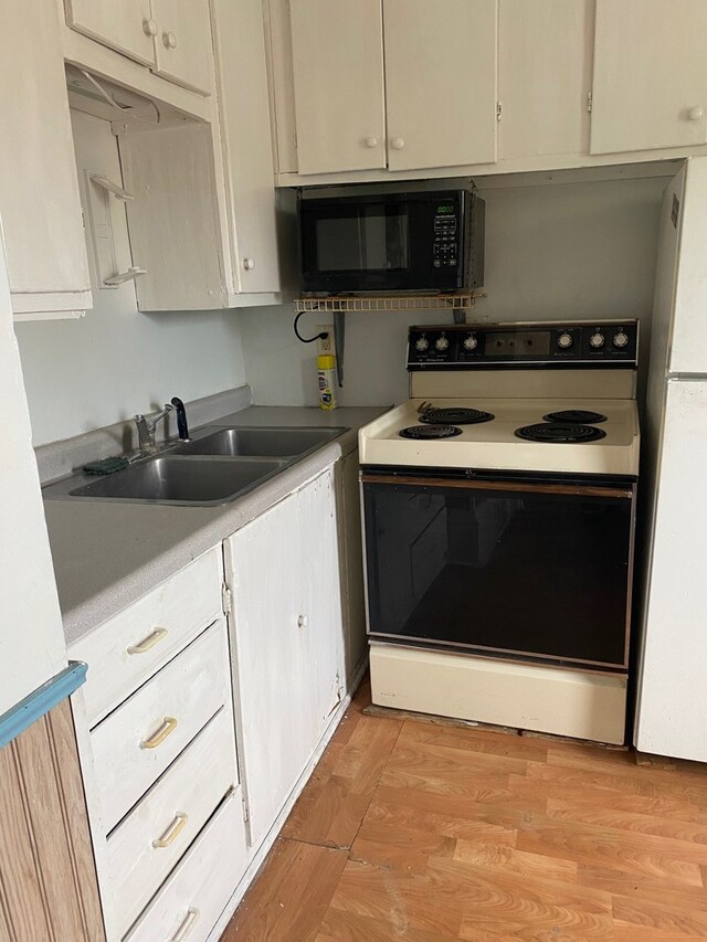 kitchen with light hardwood / wood-style flooring, sink, and white appliances