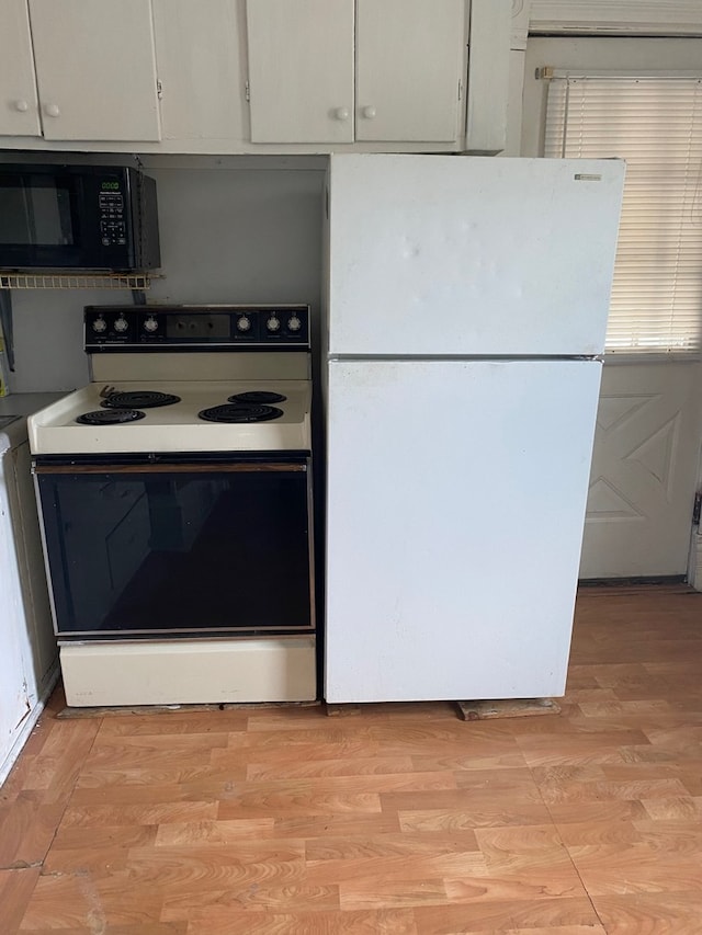 627 Hennepin St, Lasalle, IL 61301 - kitchen featuring white cabinets, light wood finished floors, and white appliances