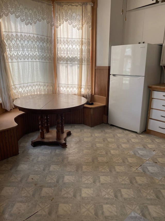 dining space featuring wood walls