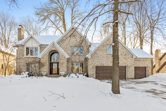 tudor house featuring a garage