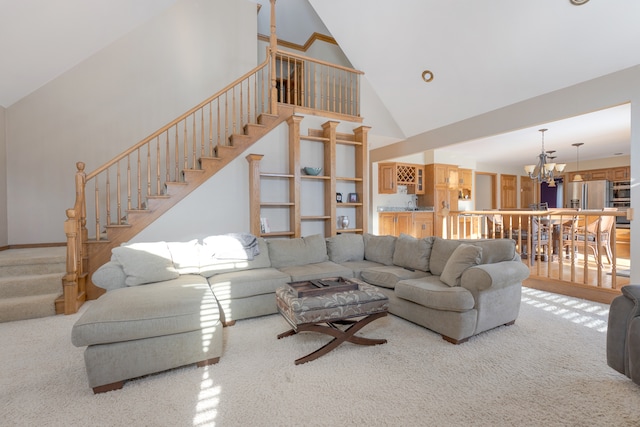 carpeted living room with an inviting chandelier and high vaulted ceiling