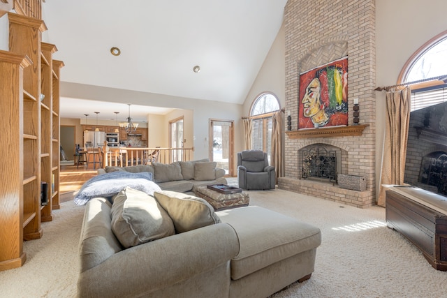 living room featuring high vaulted ceiling, light colored carpet, and a fireplace