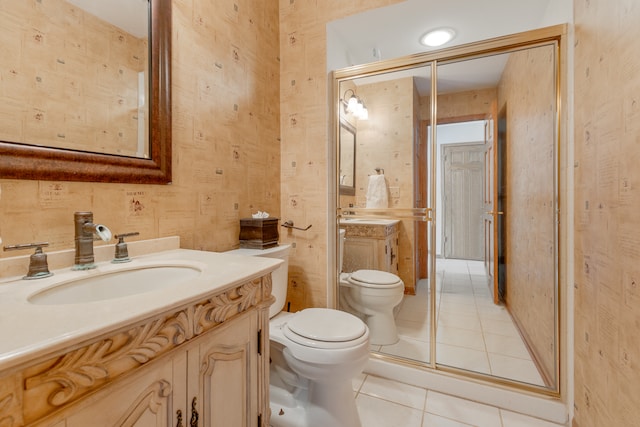 bathroom featuring vanity, toilet, tile patterned floors, and walk in shower