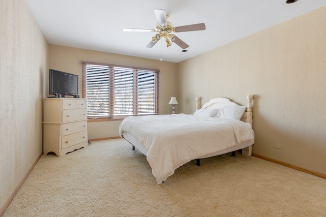 bedroom with ceiling fan and light carpet