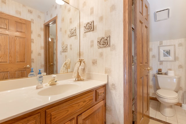 bathroom featuring vanity, toilet, and tile patterned flooring