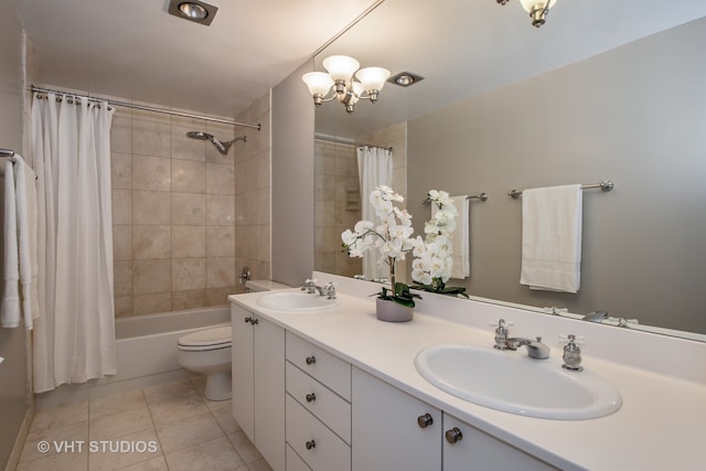 full bathroom with tile patterned flooring, vanity, toilet, and shower / bath combo with shower curtain