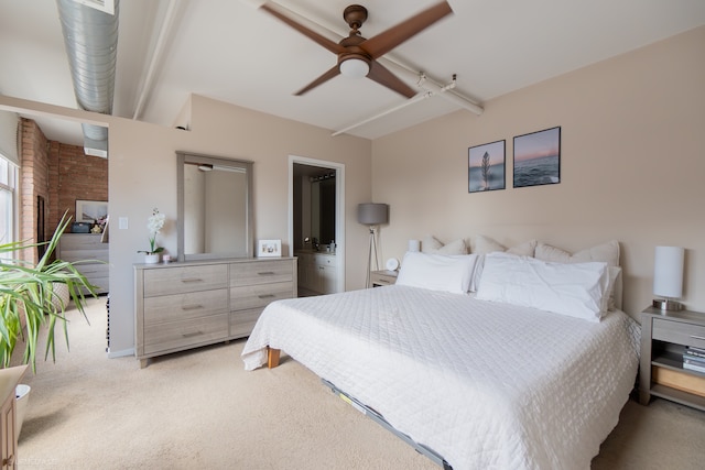 bedroom with ceiling fan, ensuite bath, and carpet floors