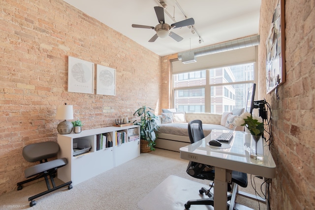 carpeted office featuring brick wall and ceiling fan