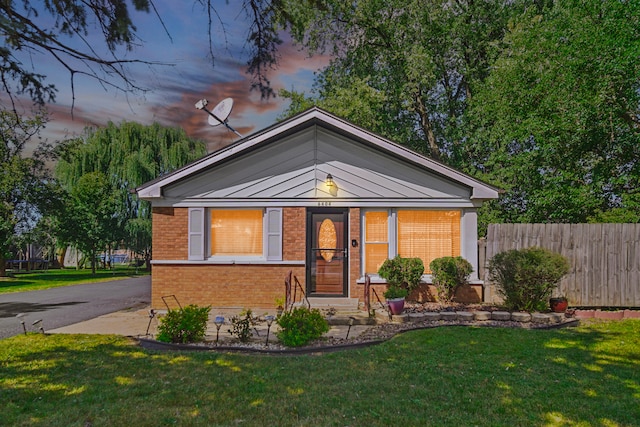 bungalow-style house with a yard